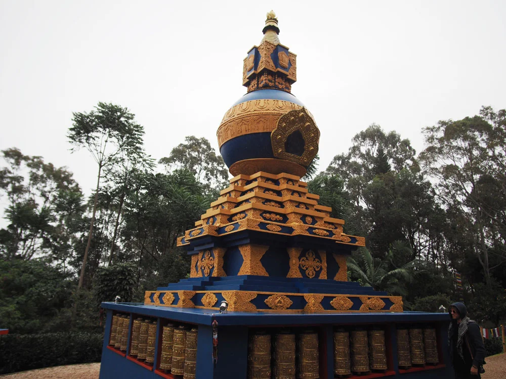Kalachakra Stupa with brass mani wheels at its base - each containing 130,000 prayers beat into the metal by Nepalese craftsmen. 