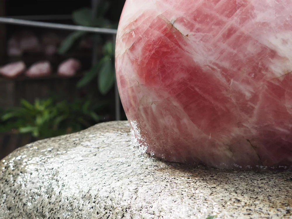 The heart of the property, a 310 kilogram rose quartz crystal sphere rotating in 0.3 mm of water 