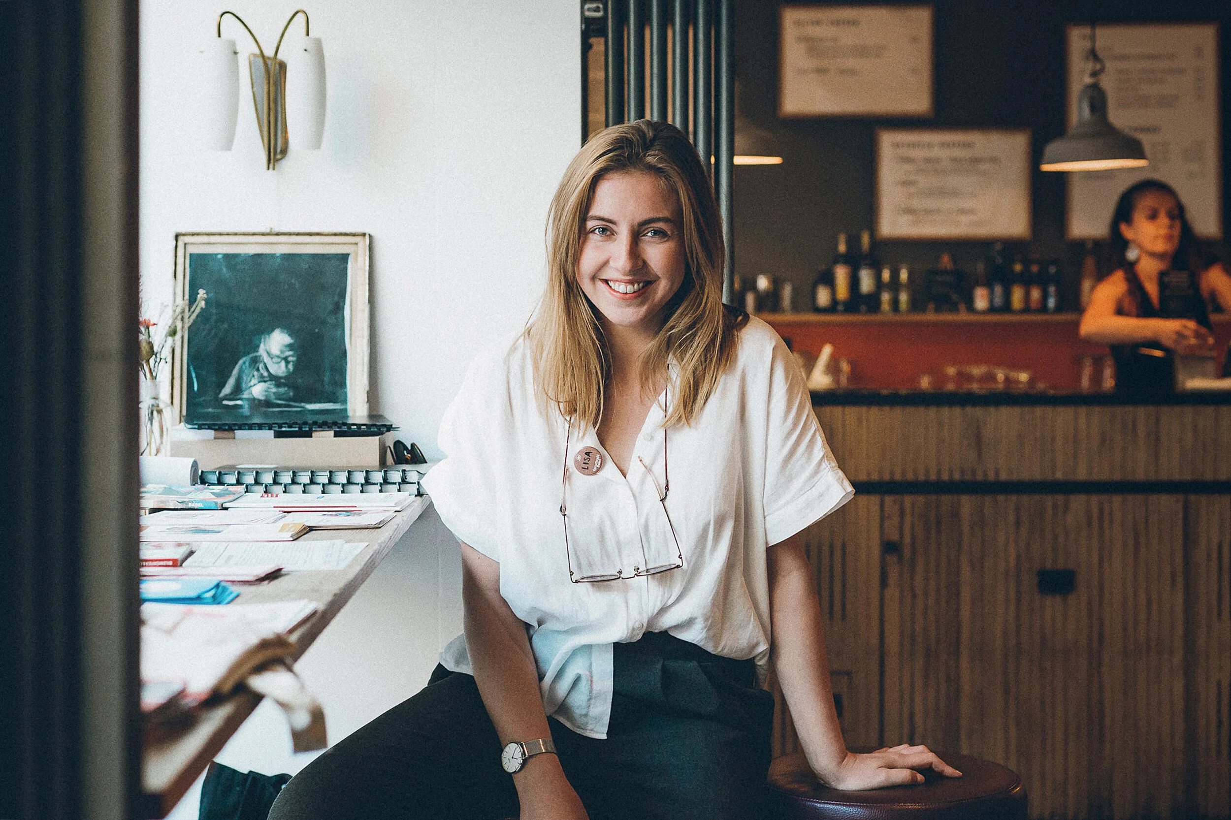 Smiling portrait of a woman sitting in a coffee shop