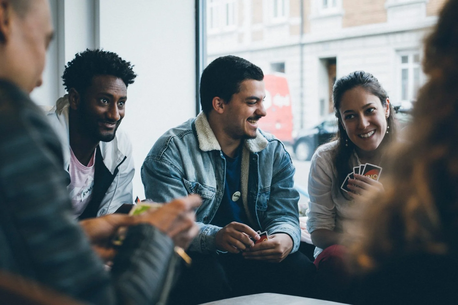 Smiling participants of Sprachcafé Basel at Café Frühling, Basel