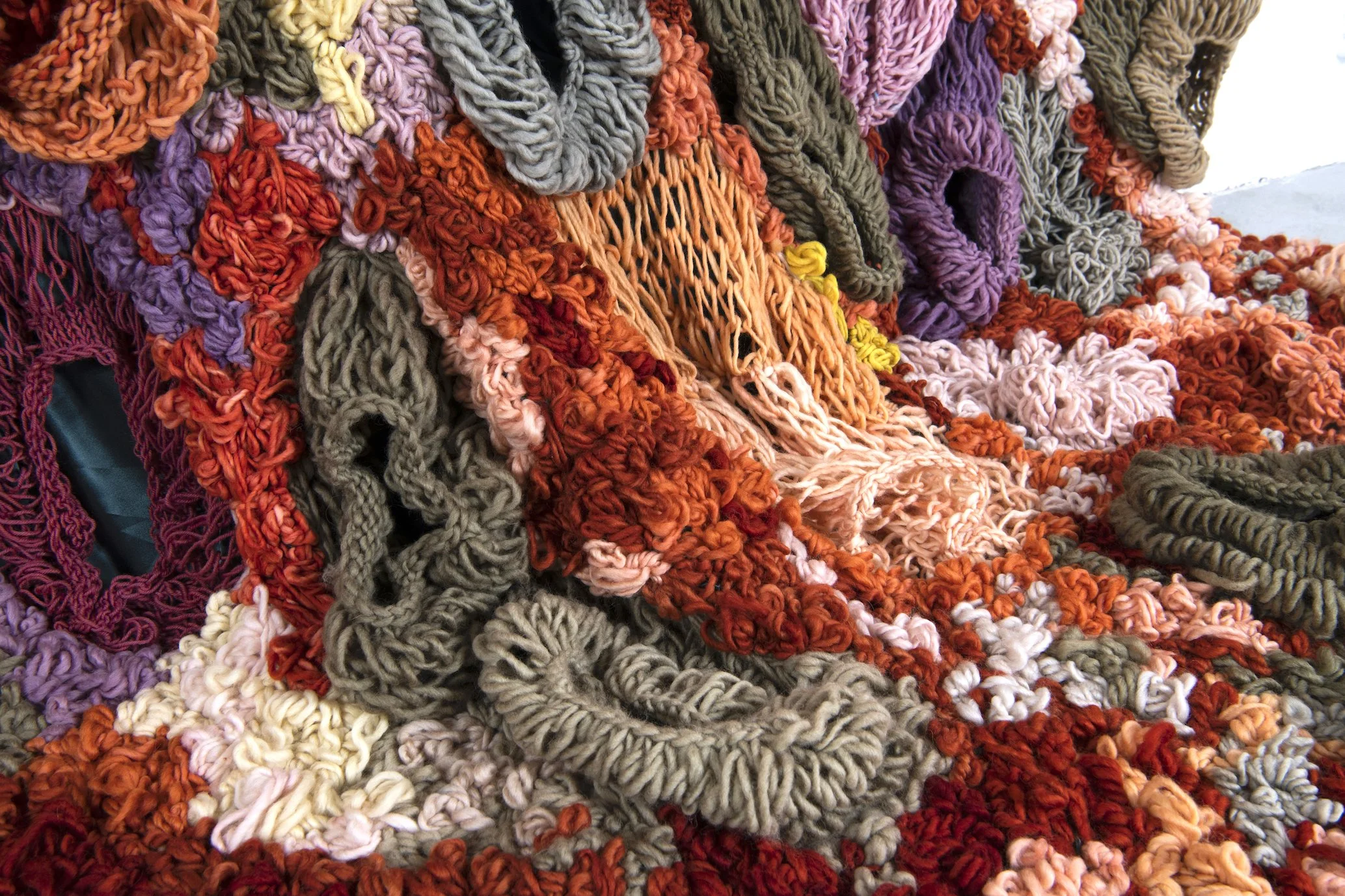 Ikke her. Ikke borte. (Not here. Not gone.) (2022)   Embroidery and knit on satin. Natural dyed yarn (pine cones, pine tree, avocado, cochenial insect, spinach, birch, madder, rhubarb, tree lichens). Wood.  4,04x3,28m