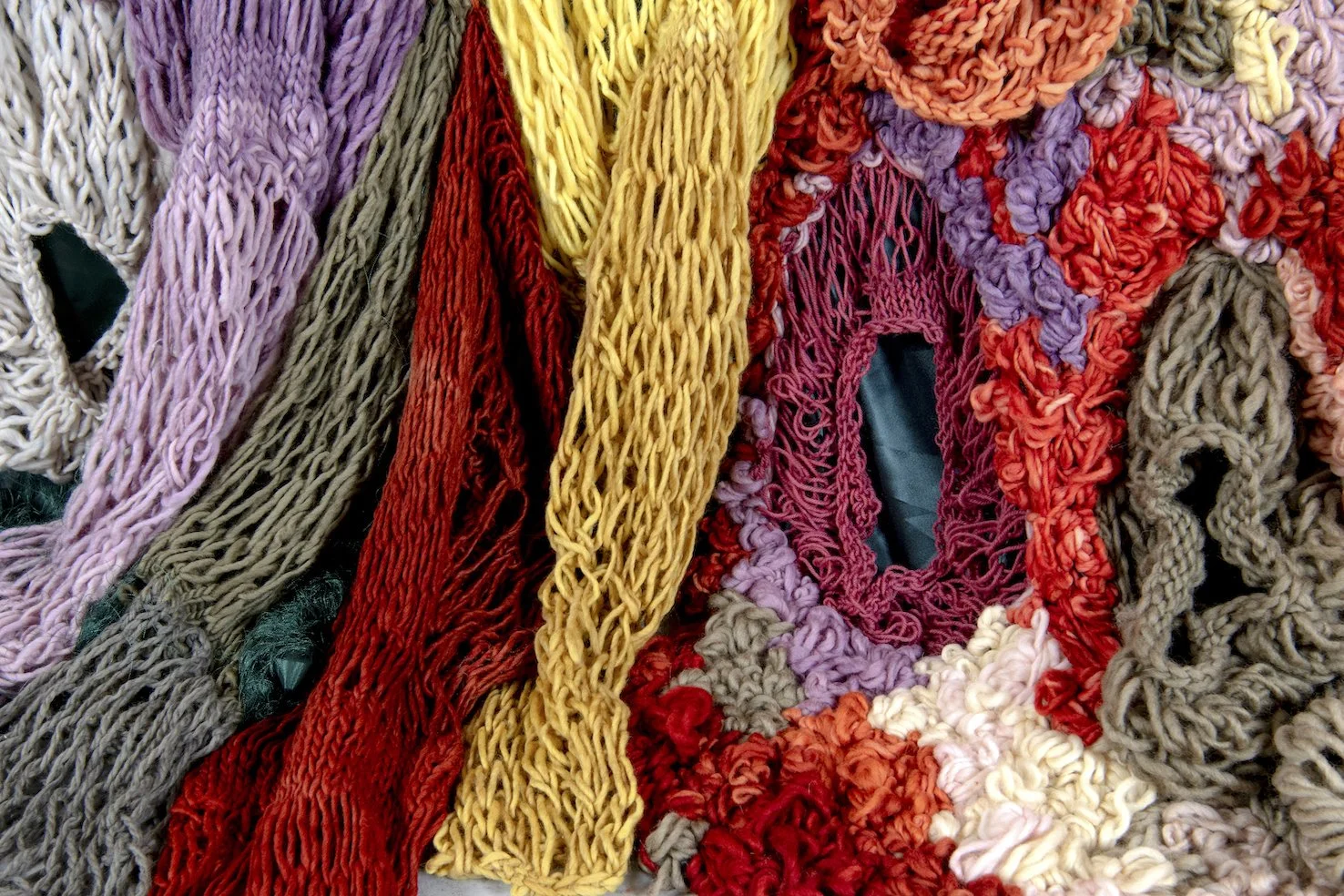 Ikke her. Ikke borte. (Not here. Not gone.) (2022)   Embroidery and knit on satin. Natural dyed yarn (pine cones, pine tree, avocado, cochenial insect, spinach, birch, madder, rhubarb, tree lichens). Wood.  4,04x3,28m