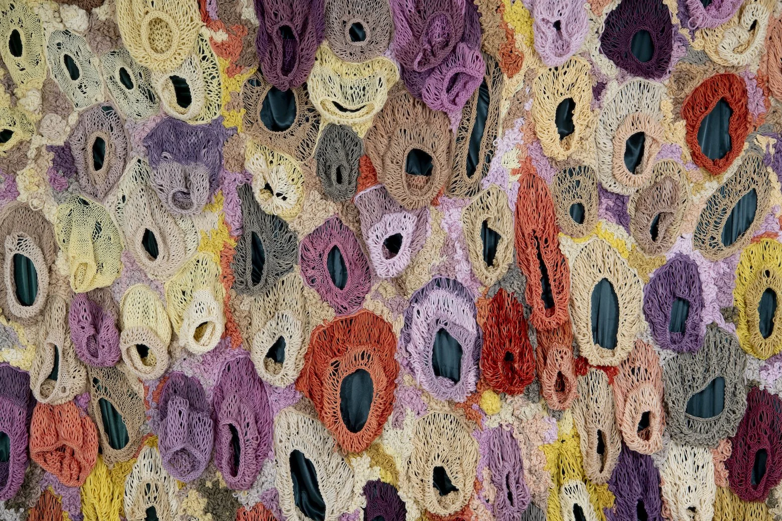 Ikke her. Ikke borte. (Not here. Not gone.) (2022)   Embroidery and knit on satin. Natural dyed yarn (pine cones, pine tree, avocado, cochenial insect, spinach, birch, madder, rhubarb, tree lichens). Wood.  4,04x3,28m