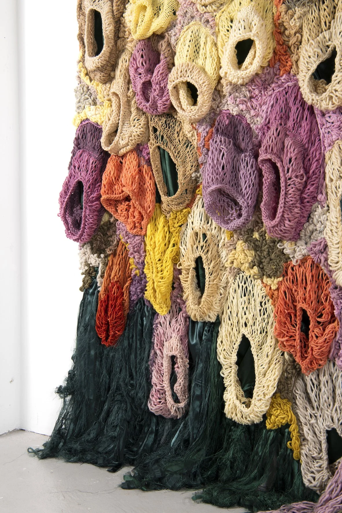 Ikke her. Ikke borte. (Not here. Not gone.) (2022)   Embroidery and knit on satin. Natural dyed yarn (pine cones, pine tree, avocado, cochenial insect, spinach, birch, madder, rhubarb, tree lichens). Wood.  4,04x3,28m