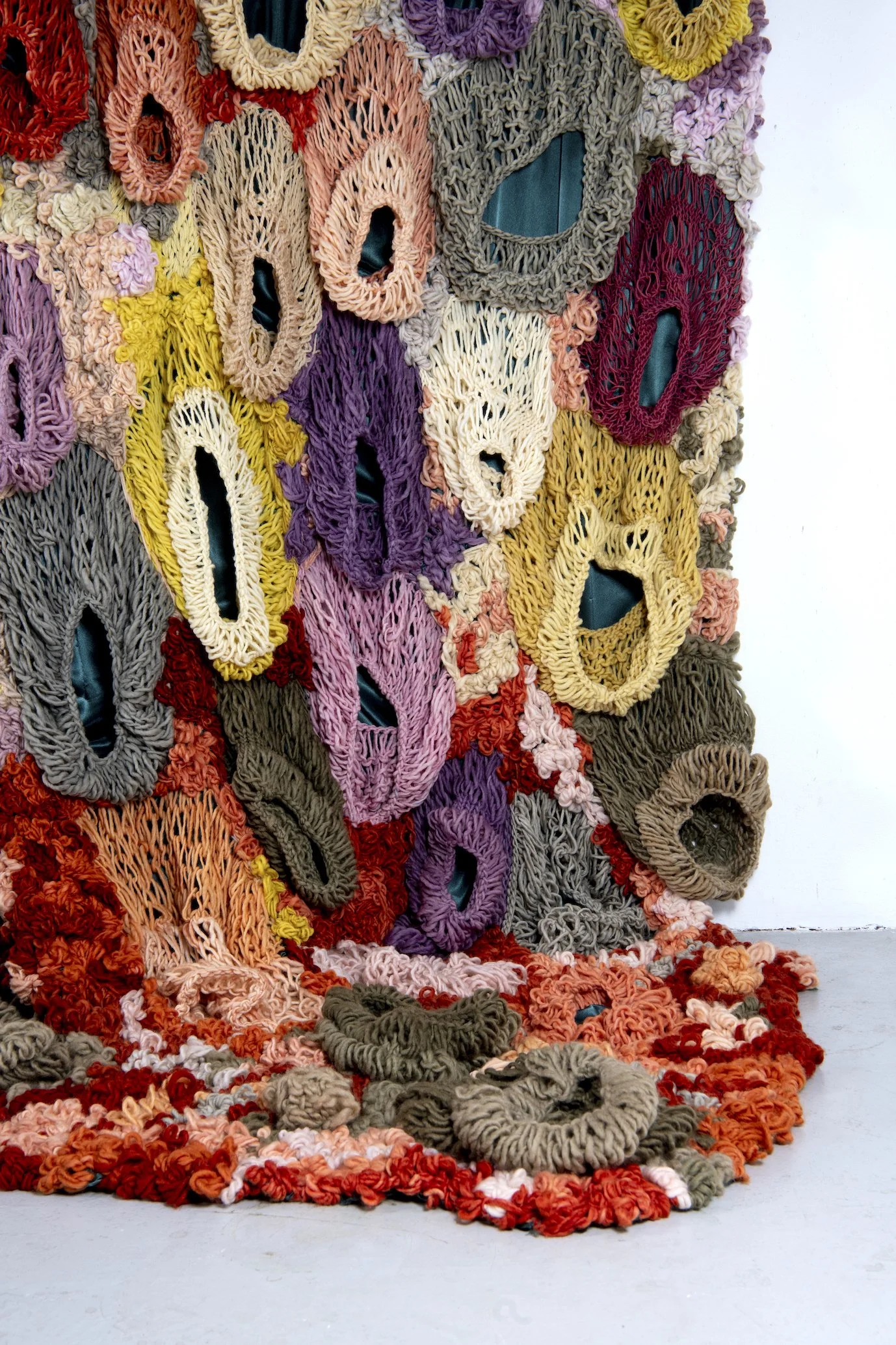 Ikke her. Ikke borte. (Not here. Not gone.) (2022)   Embroidery and knit on satin. Natural dyed yarn (pine cones, pine tree, avocado, cochenial insect, spinach, birch, madder, rhubarb, tree lichens). Wood.  4,04x3,28m