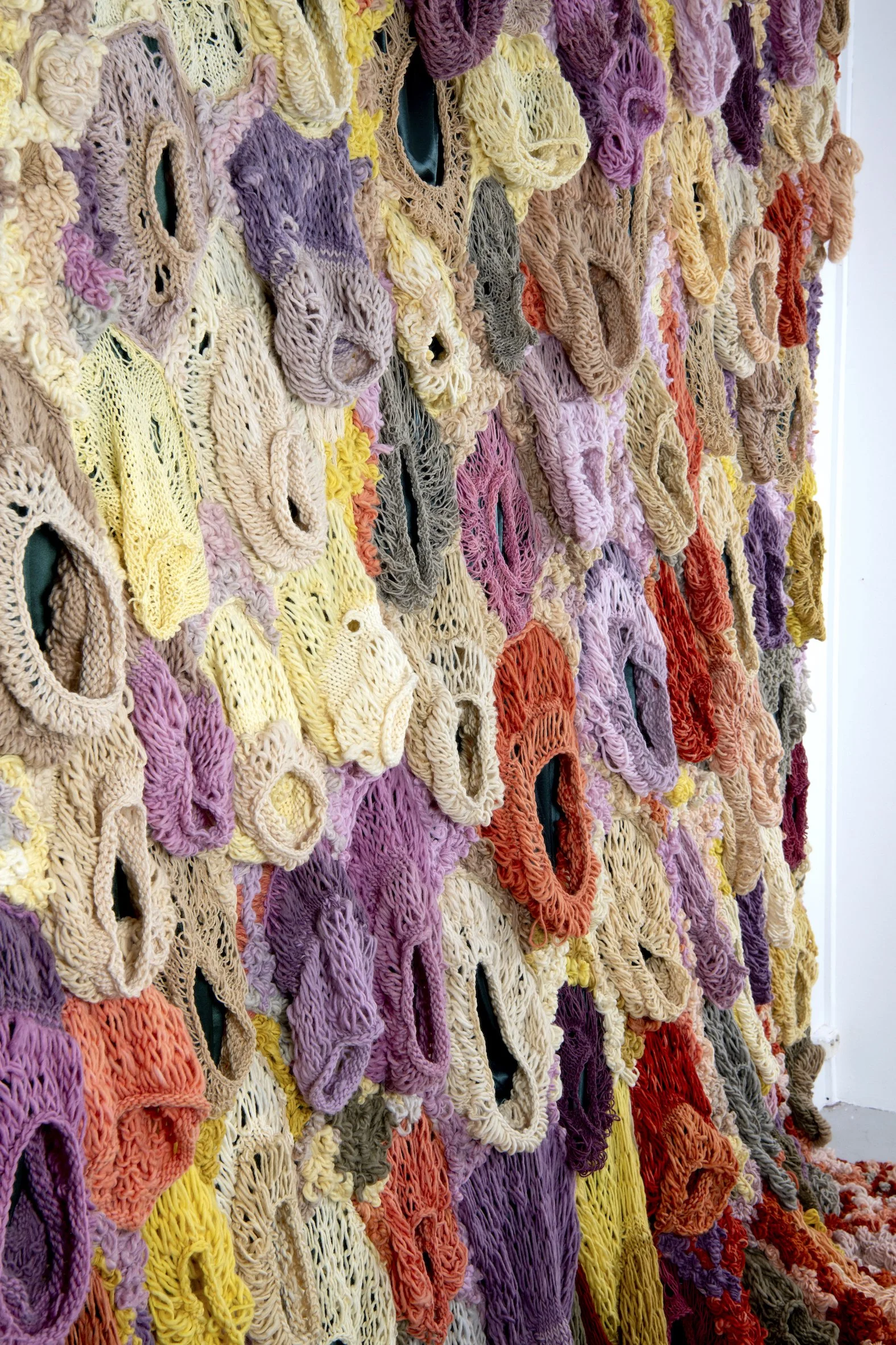 Ikke her. Ikke borte. (Not here. Not gone.) (2022)   Embroidery and knit on satin. Natural dyed yarn (pine cones, pine tree, avocado, cochenial insect, spinach, birch, madder, rhubarb, tree lichens). Wood.  4,04x3,28m