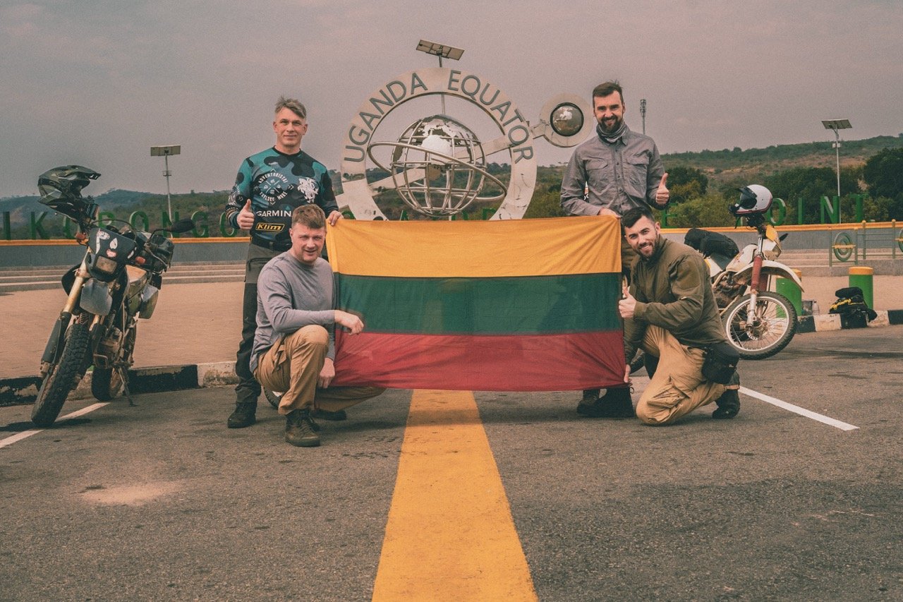 Adventure motorcyclists at the equator in Uganda