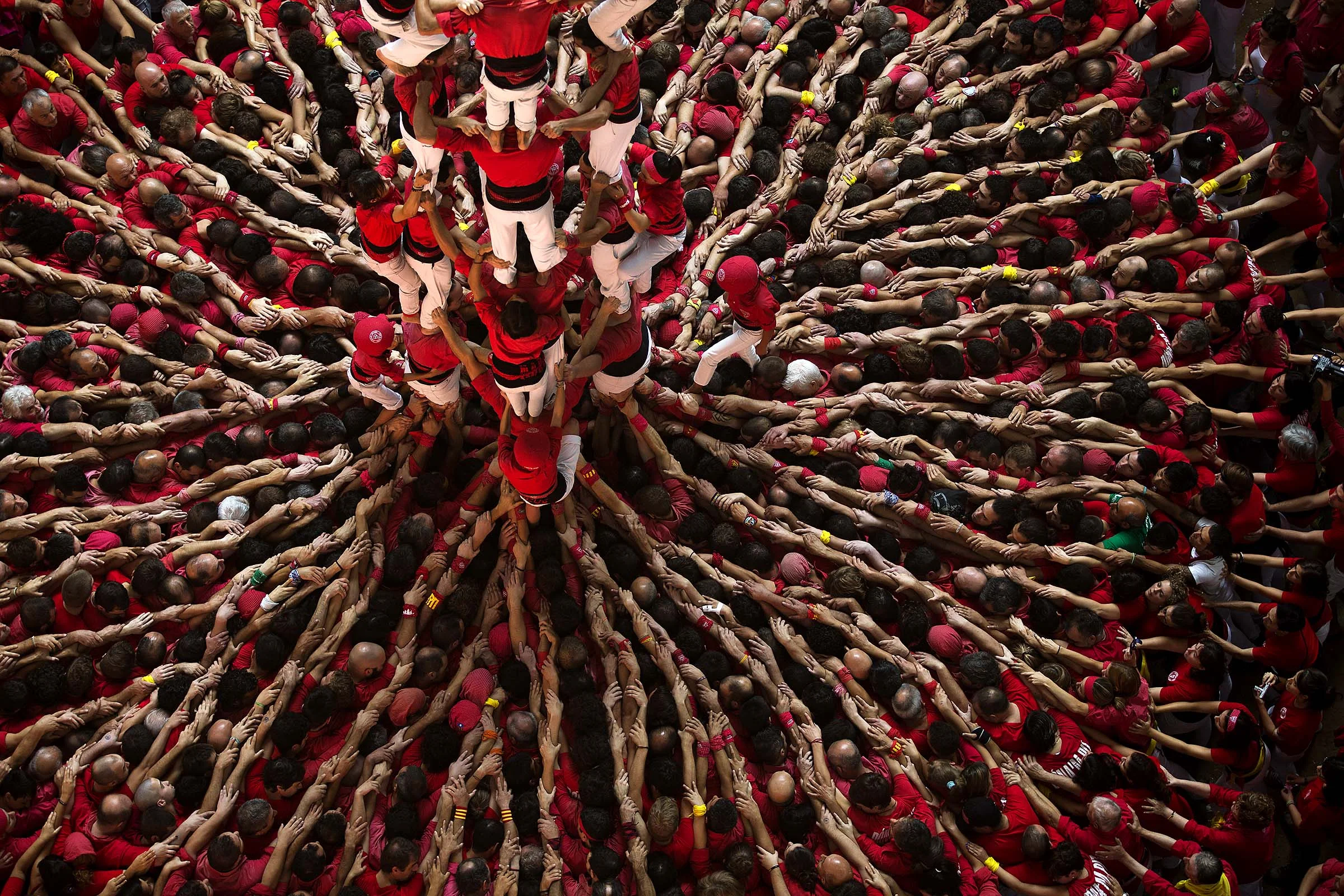 Members of the Castellers Joves Xiquets de Valls try to complete their human tower during the 25th Human Tower Competition in Tarragona, Spain. (Emilio Morenatti/Associated Press)