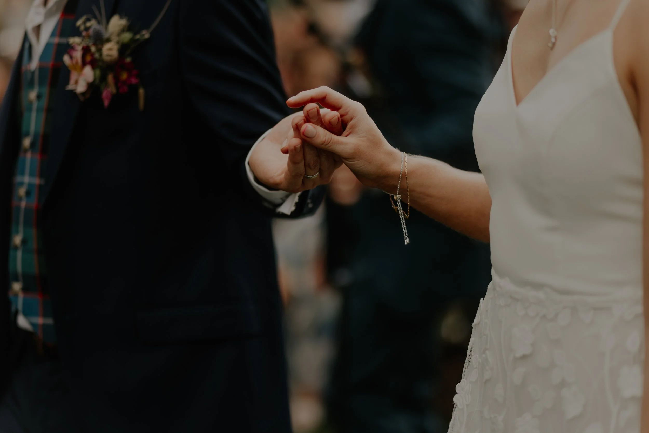 Jen and Aaron holding hands during their wedding ceremony at The Rhynd.
