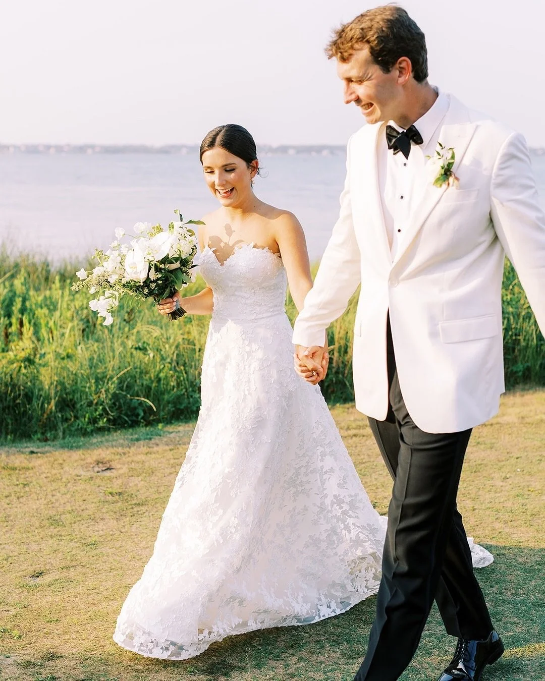 Love, laughter, and a little coastal breeze 🇺🇸✨ Wishing everyone a beautiful Labor Day!

Gown: @sarehnouri
Photography @perryvaile
Wedding planning &amp; design @stephanieshaul
Venue @crystalcoastcountryclub @crystalcoastccweddings
Florals @hathawa