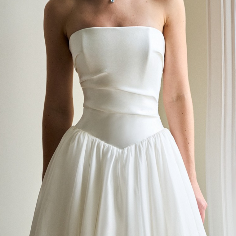 Caroline Castigliano strapless wedding gown featuring clean architectural lines and a sculptural silhouette.