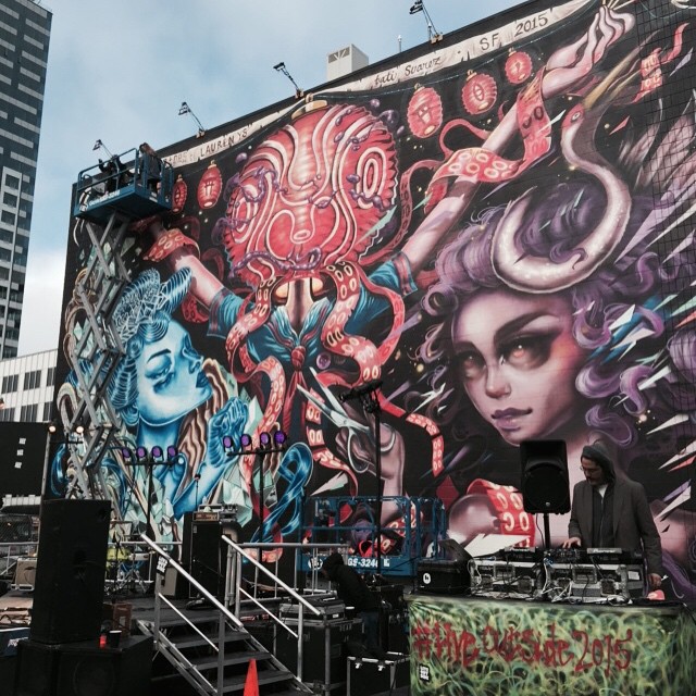 @lolo_ys putting the finishing in her mural with @caratoes and @tatunga at the corner of Van Ness and Market in San Francisco.
