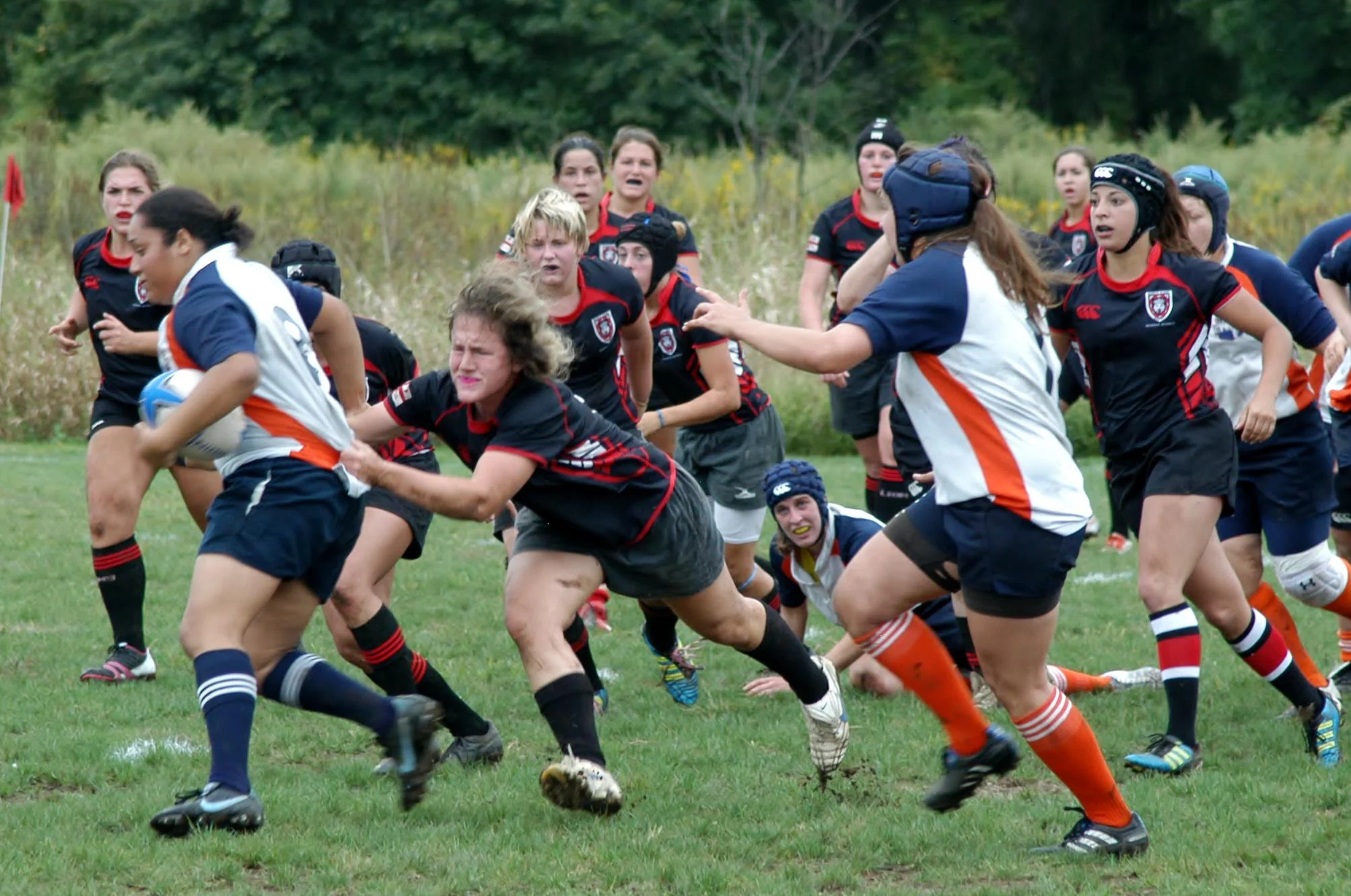Leenie taking down her opponent in a Rugby match.