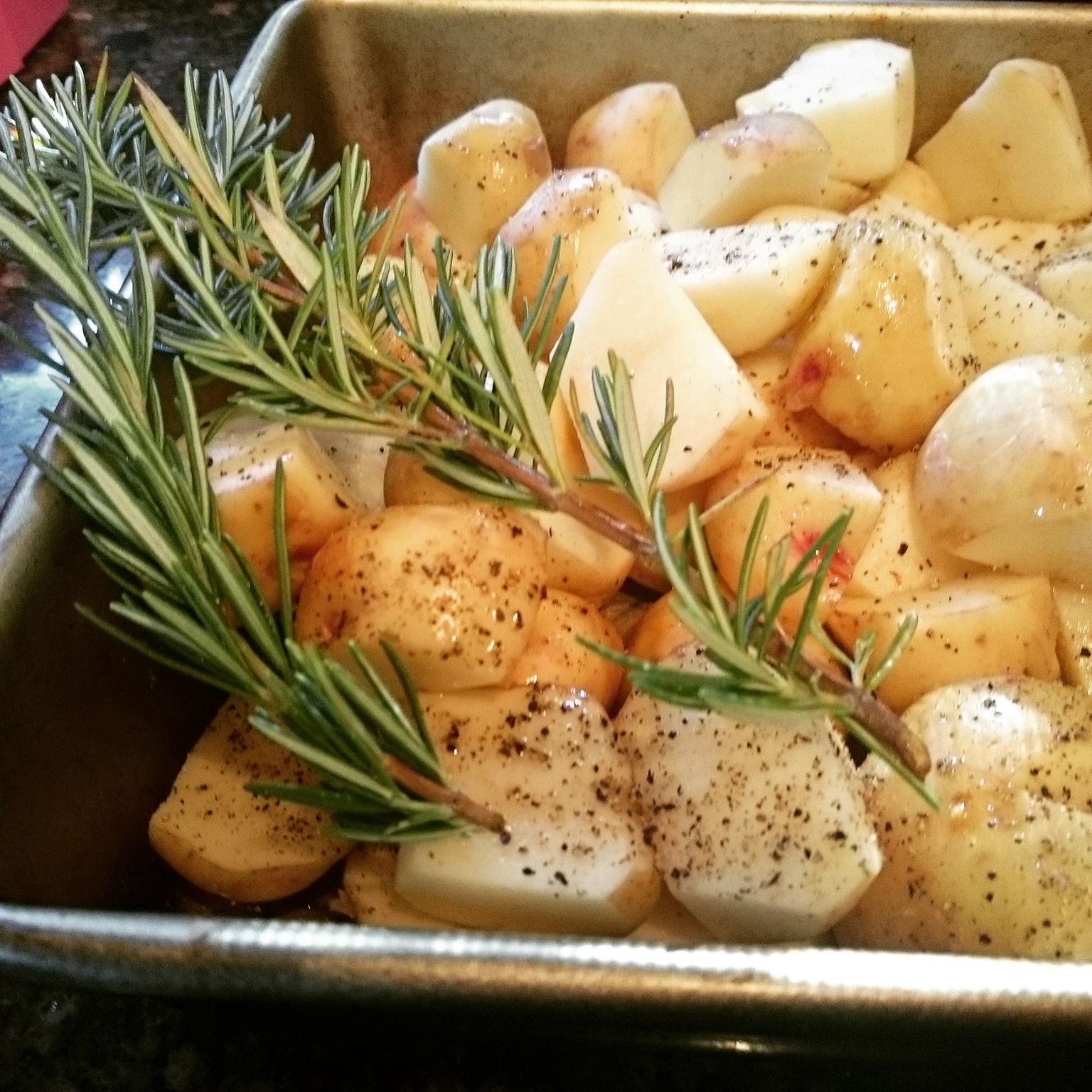 prepping local grown potatoes with fresh rosemary from our garden