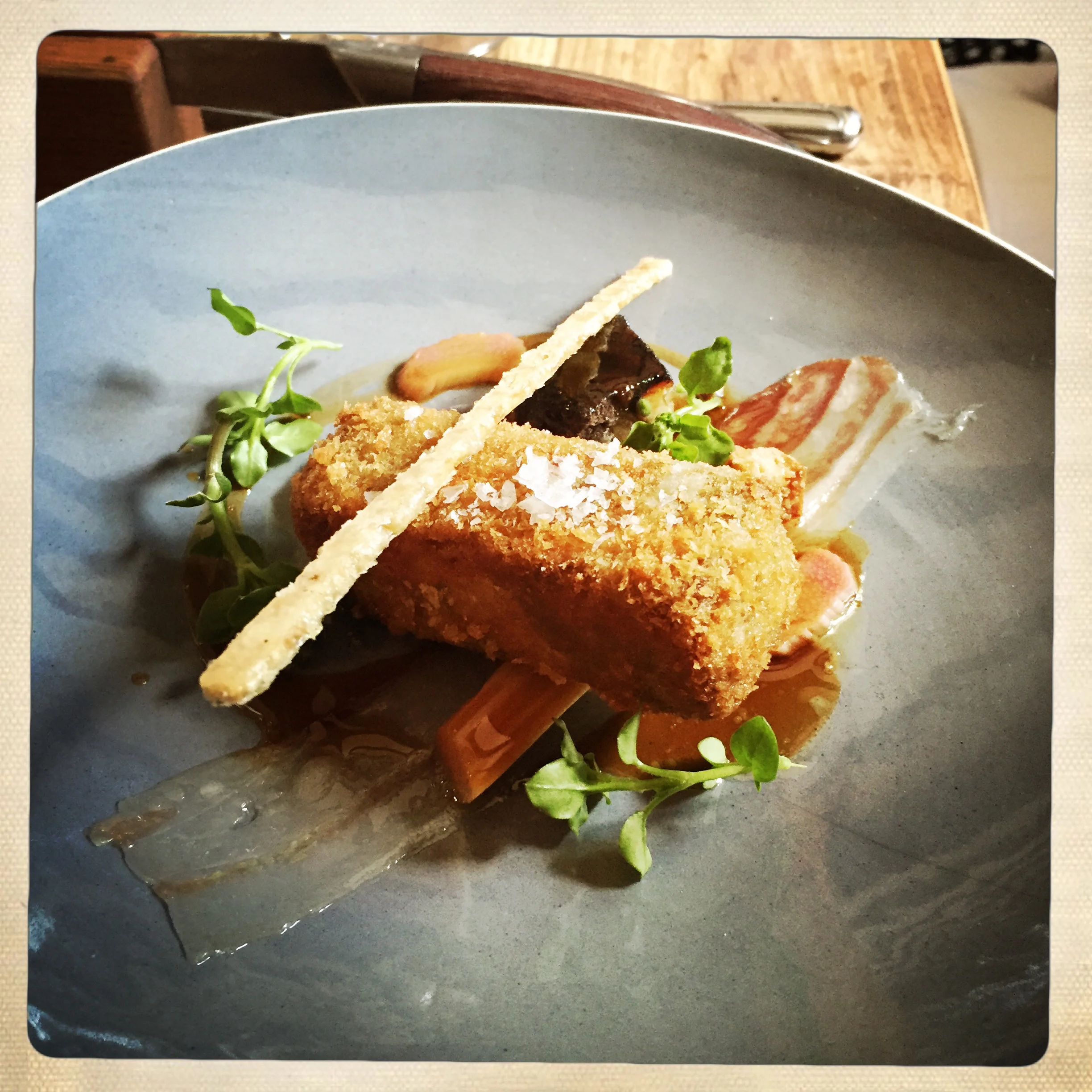 Crispy pig's head with rhubarb, pancetta & chickweed