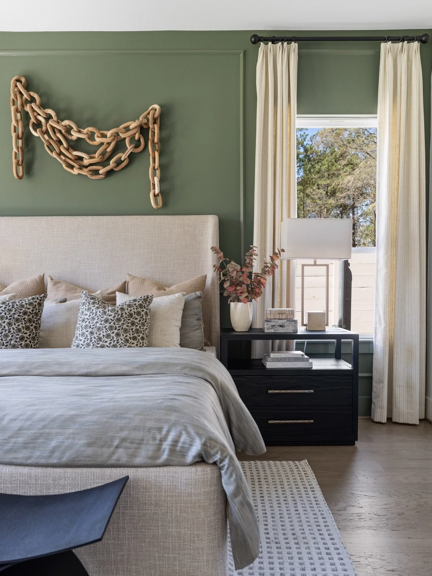 The oversized wooden chain sculpture steals the show in this moody olive green bedroom, where linen textures, layered neutrals, and sleek black accents create a perfectly curated retreat.​​​​​​​​​​​​​​​​

#InteriorDesign #BedroomDecor #HomeDecor #Bed