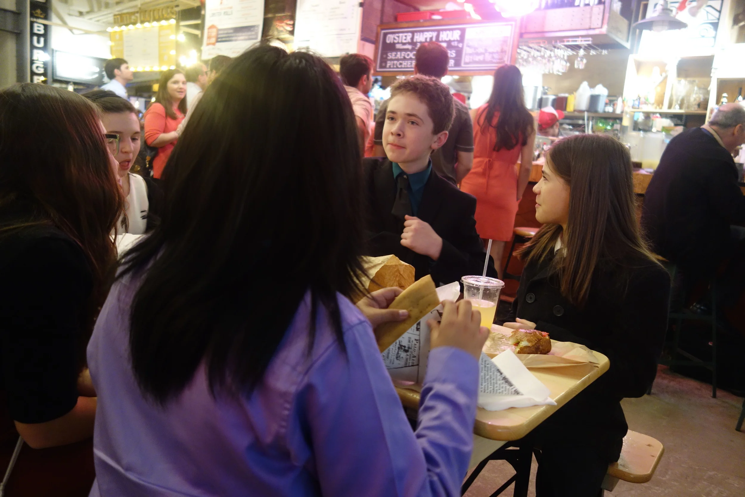 7th grader Jack, center, holds forth during dinner out in New York