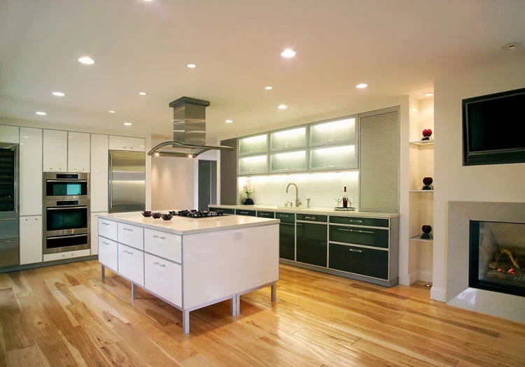 Hand hewn hickory floors are the rustic counterpoint to this modern kitchen.