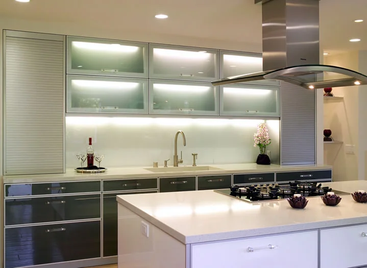 The one piece glass backsplash continues the clean look of the Caesarstone counters.