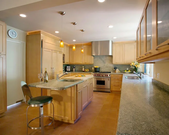 Ample honed granite counters, butcher block island, and professional appliances are a cooks dream.