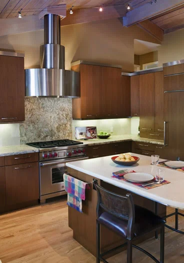 The custom stainless steel cabinetry crown and range hood make a strong statement.