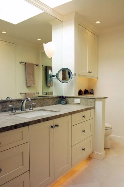 Honed stone surfaces and clean lines make this bath comfortable.