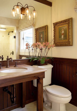 Rustic console table vanity with matching wainscot.