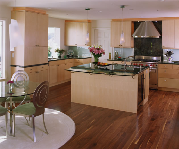 The simple maple cabinetry is contrasted by the dark granite counters and walnut floors.