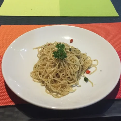 Vegan pasta with garlic, olive oil, and Thai chilis in Phuket.