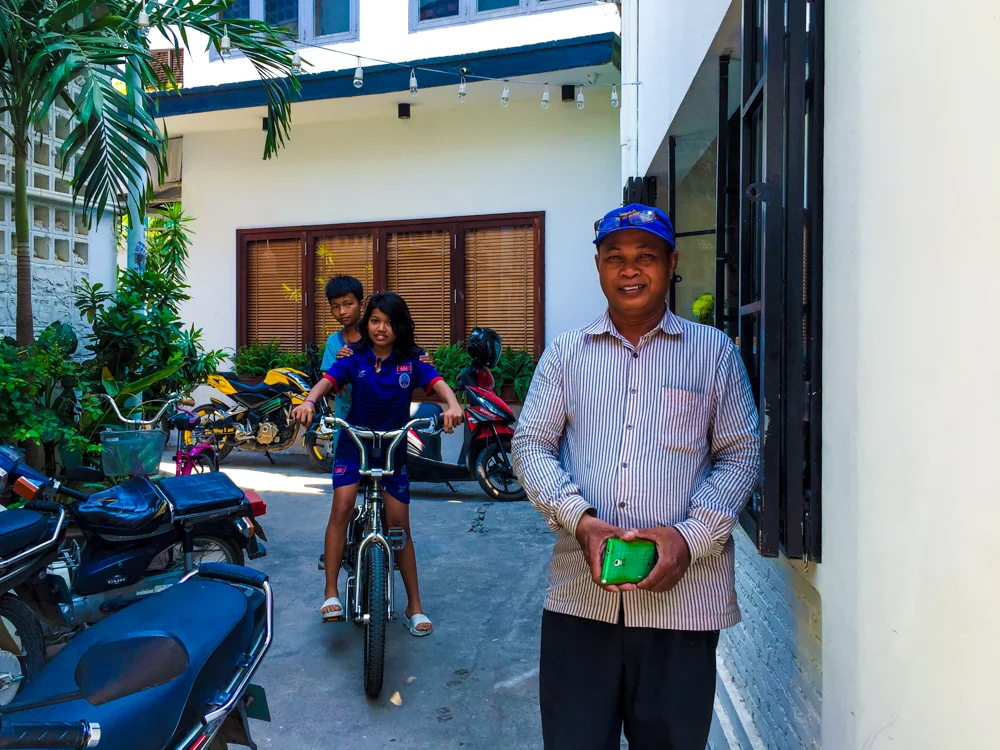 Our Tuk Tuk driver and two children play in an alley way in Phnom Penh.