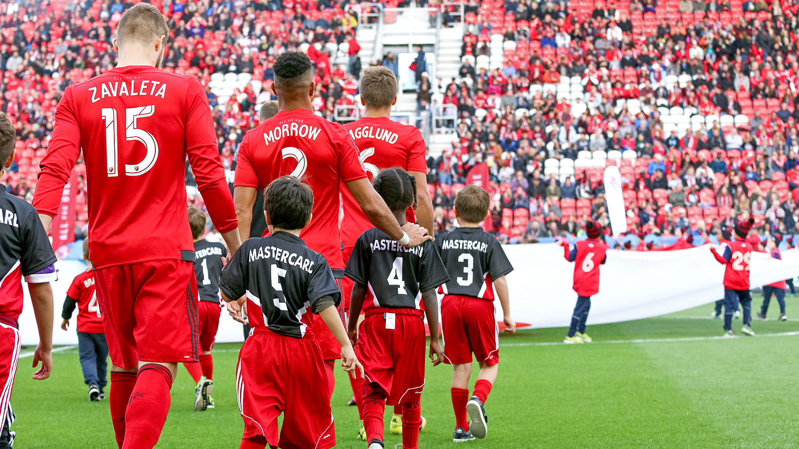 Players take to the pitch in the opening ceremonies.