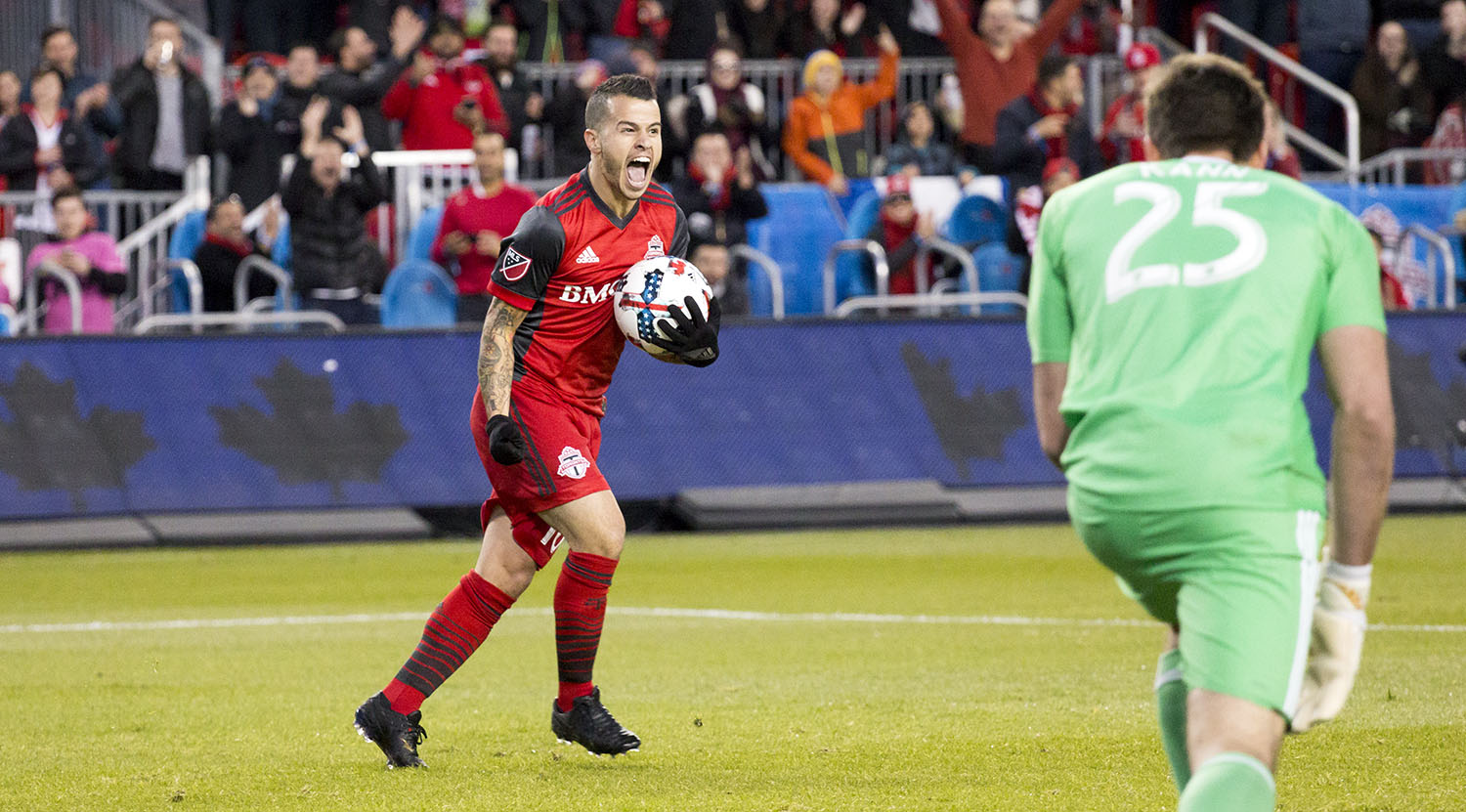 Sebastian Giovinco celebrating a goal with the ball in hand during a Major League Soccer game against Atlanta United FC. Image by Dennis Marciniak of denMAR Media.