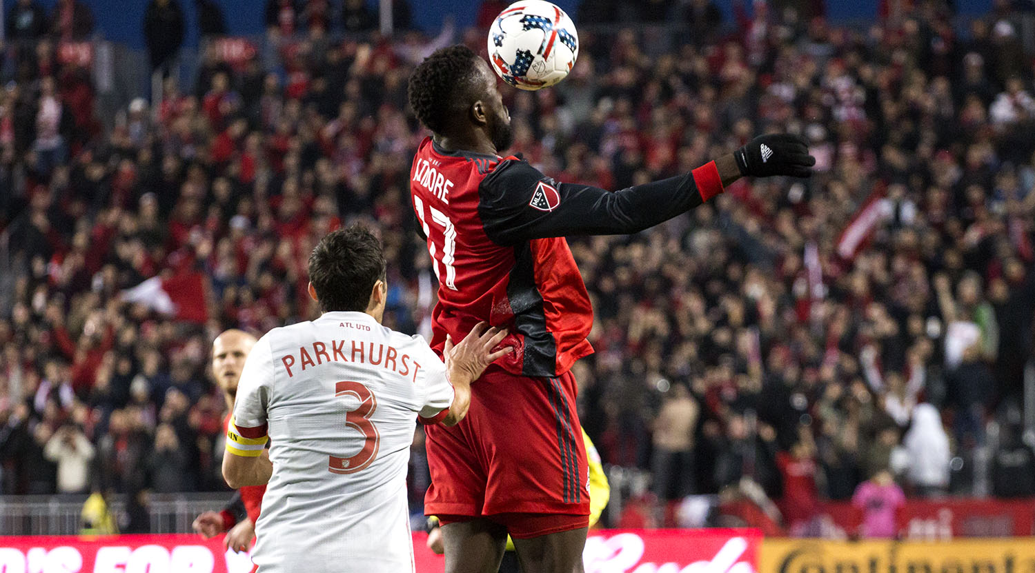 Jozy Altidore and Parkhurst go into the air for a header on the ball during a game at BMO Field. Image by Dennis Marciniak of denMAR Media.