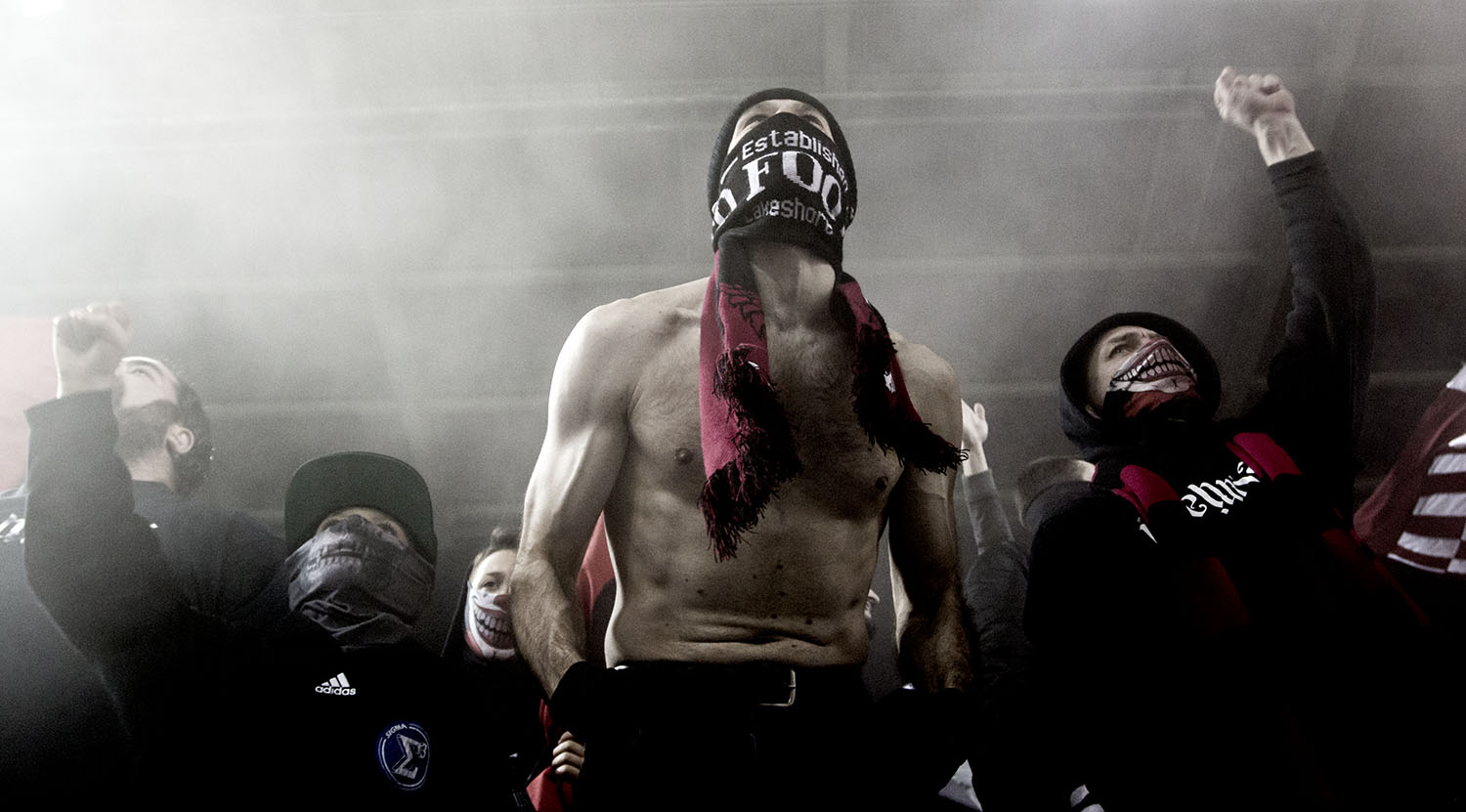 A shirtless south end supporter in the smoke during a Major League Soccer game against Atalnta United FC. Image by Dennis Marciniak of denMAR Photography.