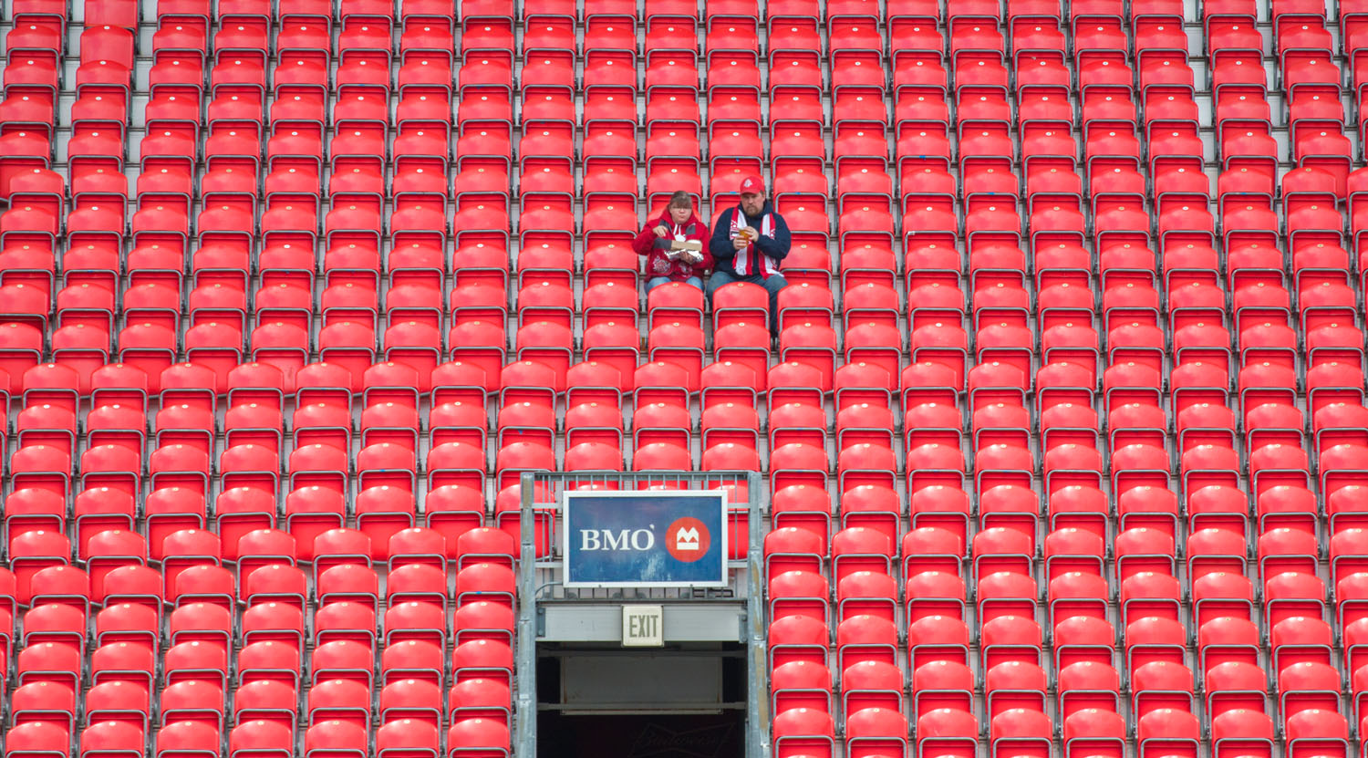 A couple enjoying some in stadium food before the Toronto FC v Minnesota United match on May 13, 2017 at BMO Field in Toronto, Canada. Image by Dennis Marciniak of denMAR Media.