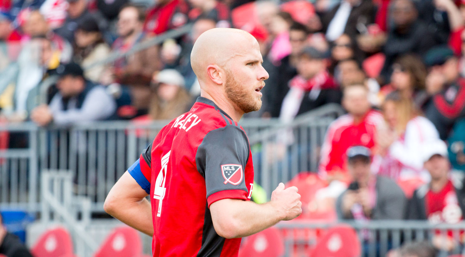 Michael Bradley running towards a corner flag during a match at BMO Field. Image by Dennis Marciniak of denMAR Media.