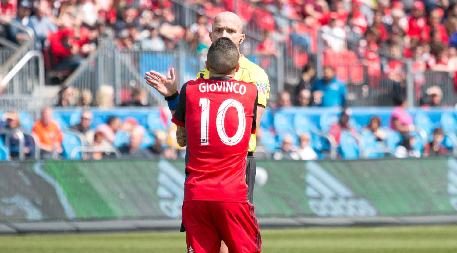 Sebastian Giovinco exchanging words with first official Allan Chapman over a call in the box. Image by Dennis Marciniak of denMAR Media.