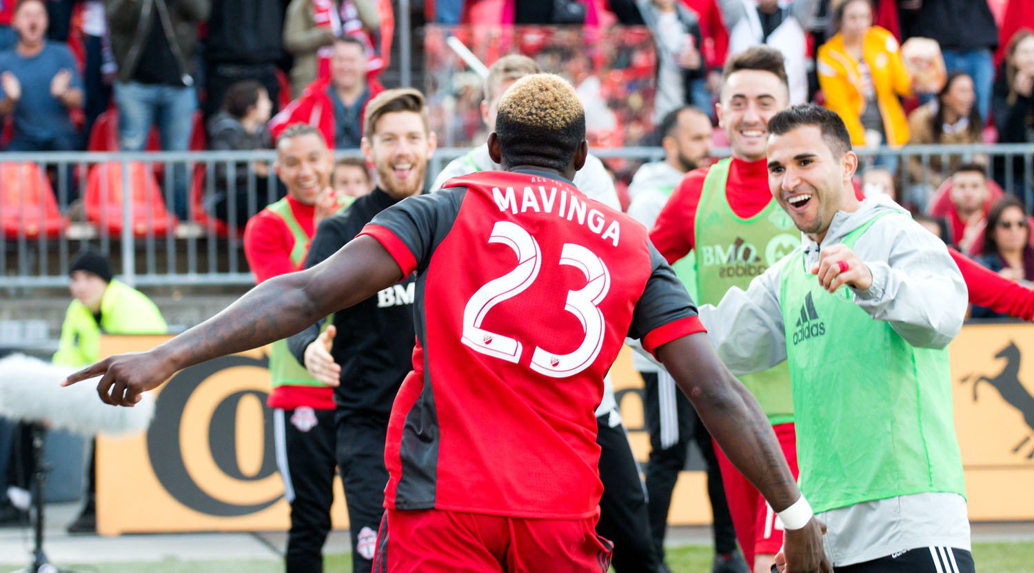 Chris Mavinga celebrating the second Toronto FC goal with players from the bench. Image by Dennis Marciniak of denMAR Photogrpahy.
