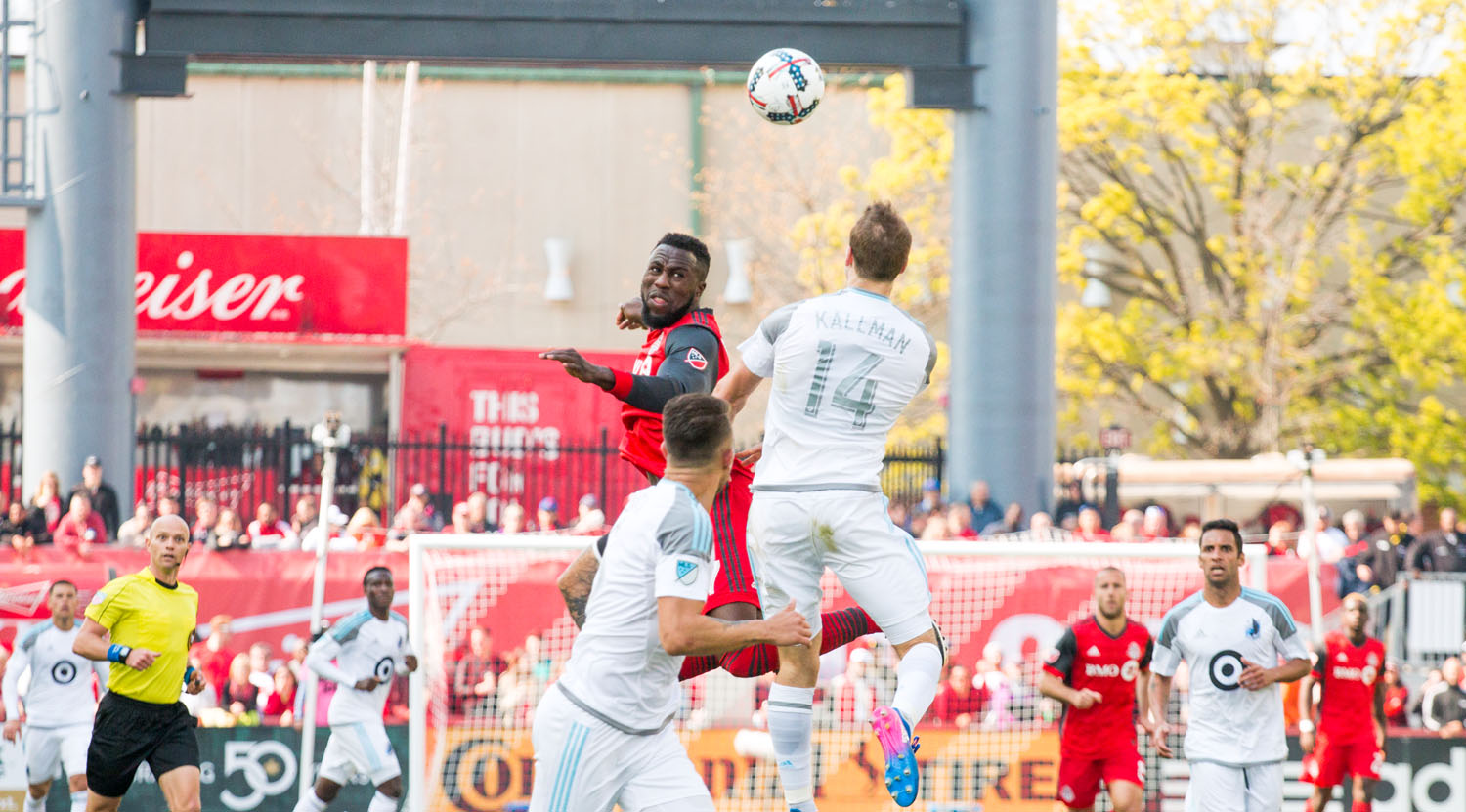 Jozy Altidore and Brent Kallmam go into the air for a header. Image by Dennis Marciniak of denMAR Media.