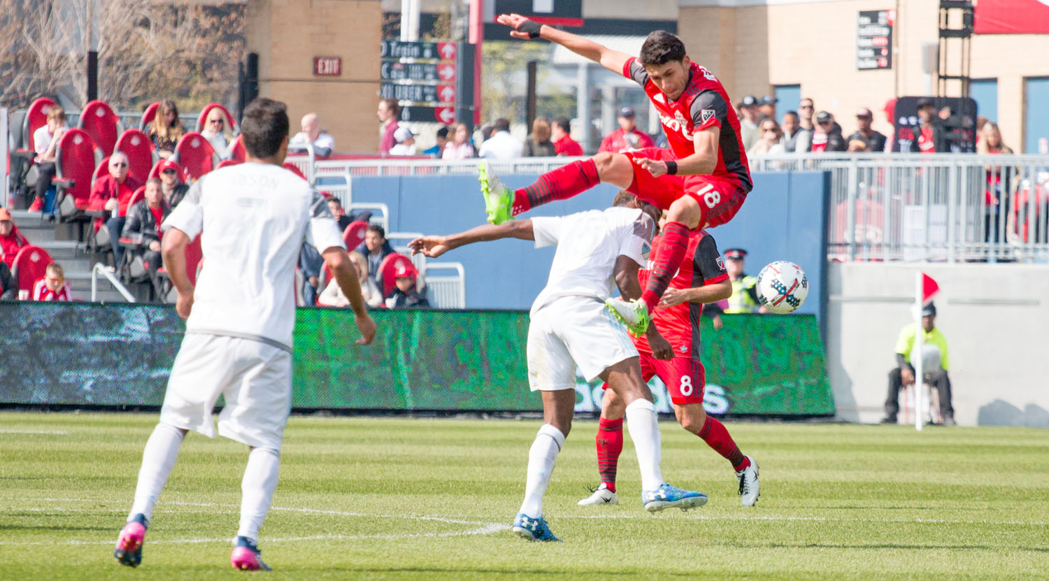 Marky Delgado on his way down to the ground from a challenge by a Minnesota United FC player. Image by Dennis Marciniak of denMAR Media.