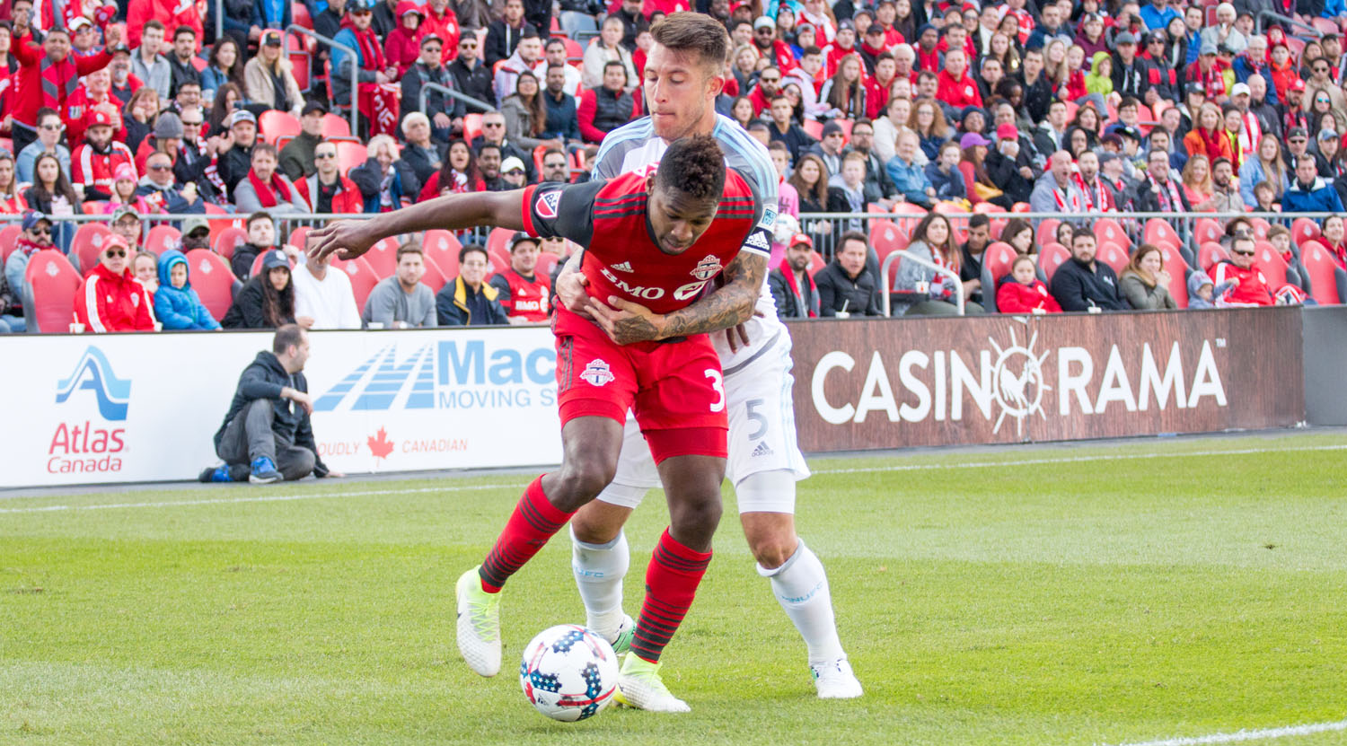 Armando Cooper being hugged tightly by Francisco Calvo during a Major League Soccer match in 2017. Image by Dennis Marciniak of denMAR Media.