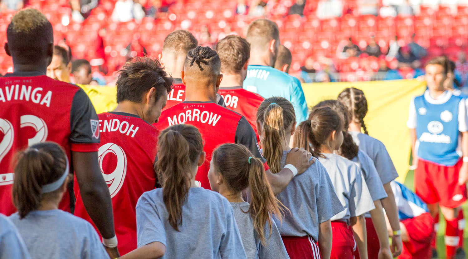 Justin Morrow heads out with player escort during the Toronto FC game against the Ottawa Fury at BMO Field in 2017. Image by Dennis Marciniak of denMAR Media.
