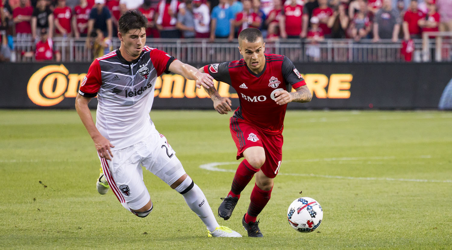 Sebastian Giovinco trying to get away from a DC United player. Image by Dennis Marciniak of denMAR Media.