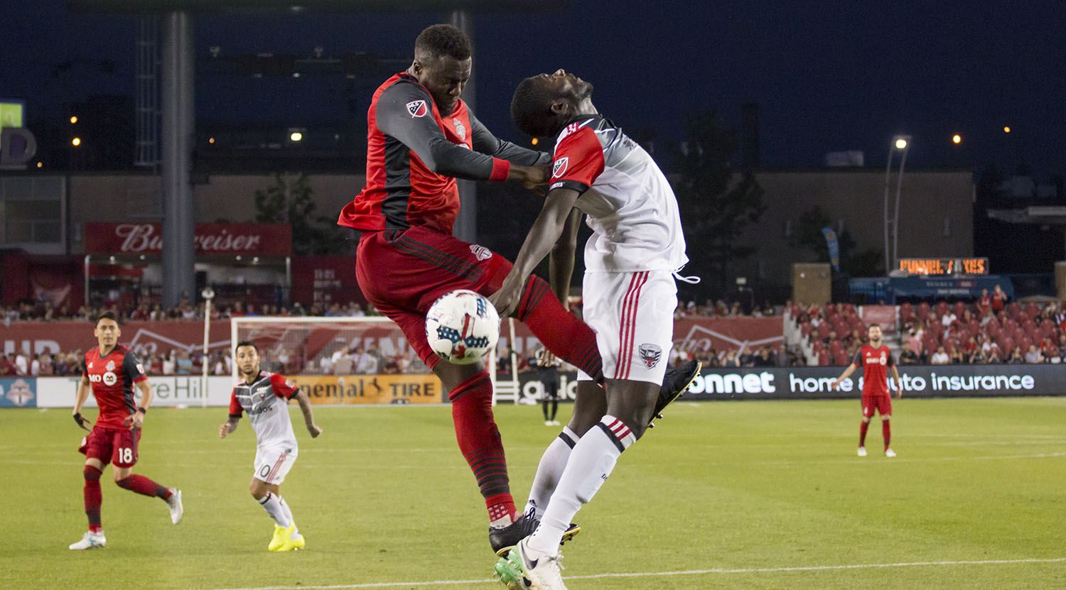 Jozy Altidore goes for the ball but ends up almost kicking a DC United player in a bad place. Image by Dennis Marciniak of denMAR Media.