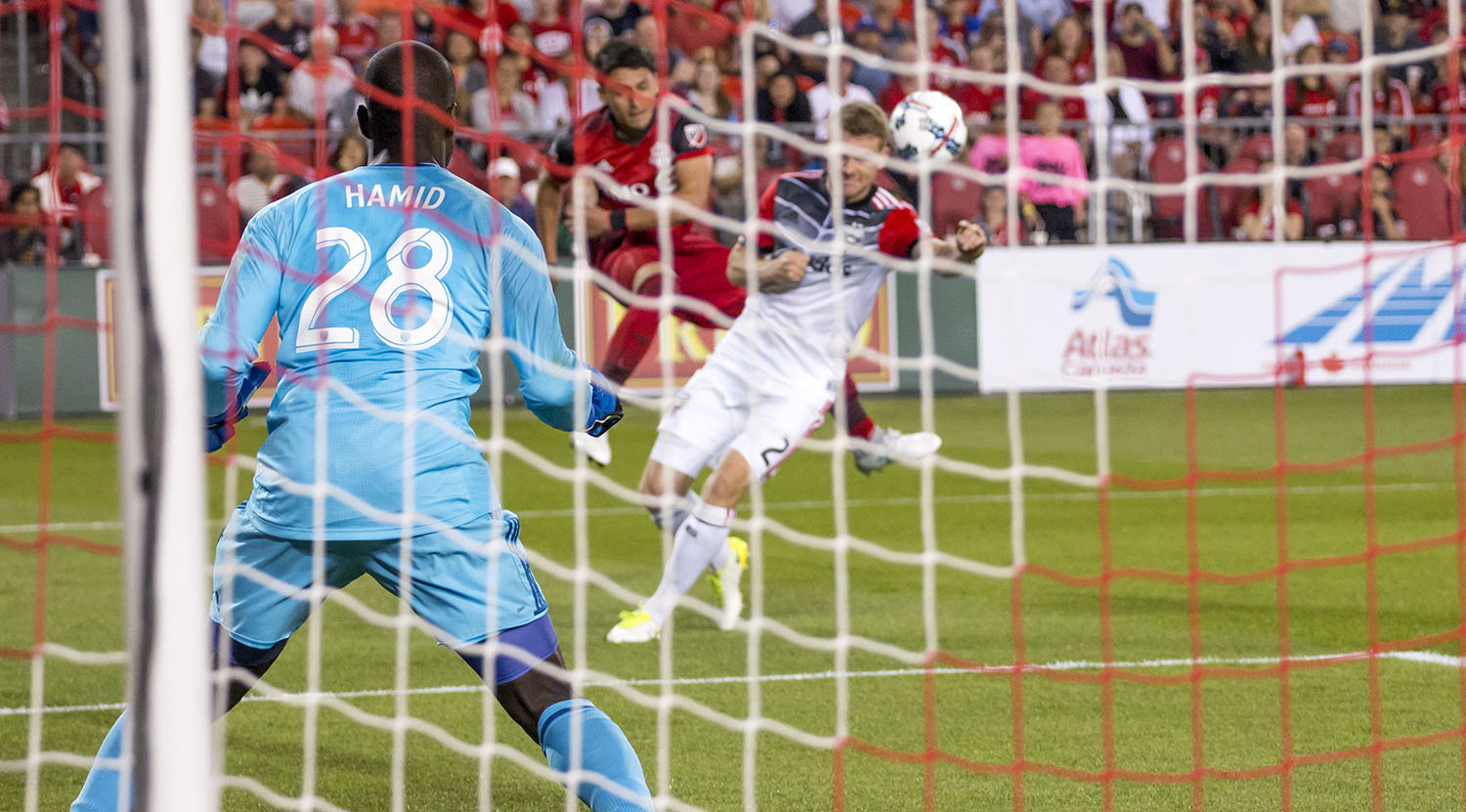 DC United's Bill Hamid trying to track the ball coming across the box. Image by Dennis Marciniak of denMAR Media.