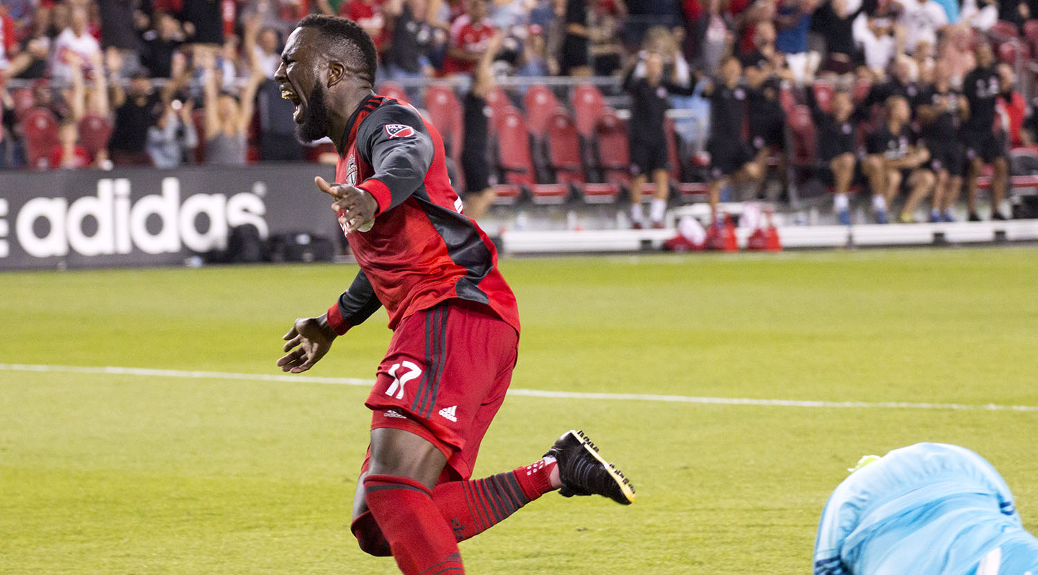 Jozy Altidore celebrating his goal running towarards the supporter's section at BMO Field. Image by Dennis Marciniak of denMAR Media.