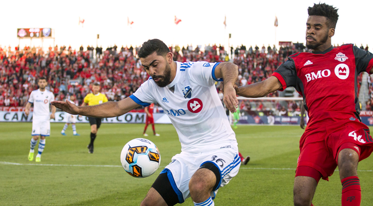 Raheem Edwards and Victor Cabrera go for the ball as the sun sets at BMO FIeld in 2017. Image by Dennis Marciniak of denMAR Media.