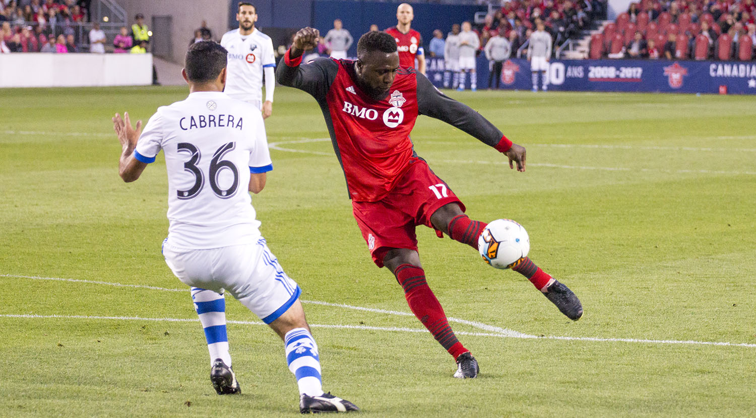 Jozy Altidore tries to take a shot on net against Montreal Impact's Cabrera who would end up blocking the ball from reaching any further. Image by Dennis Marciniak of denMAR Media.
