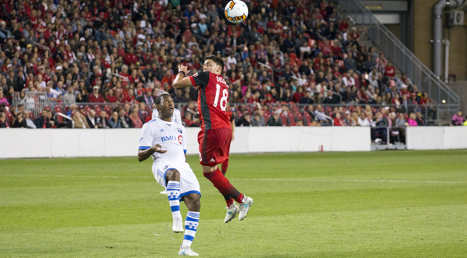 Marky Delgado goes for a head before an Montreal Impact player can get to it. Image by Dennis Marciniak of denMAR Media.