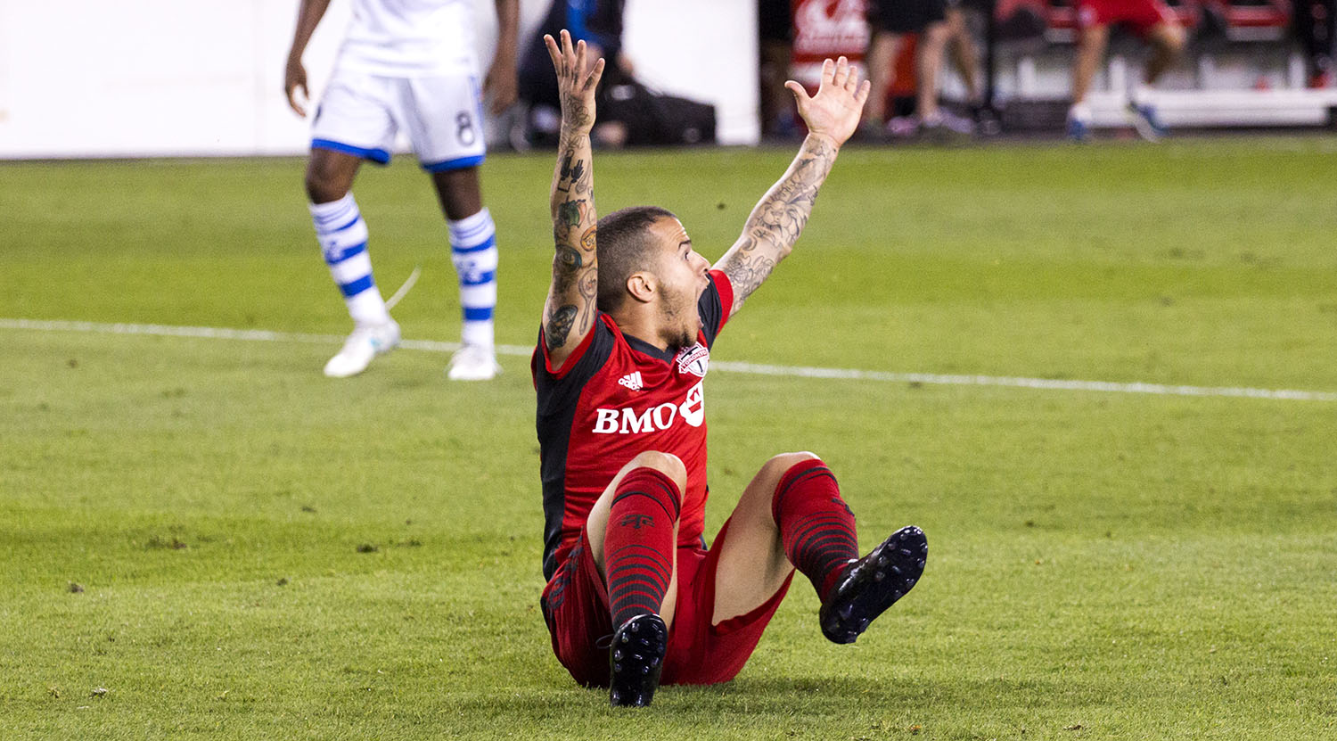 Sebastian Giovinco raises his arms in the air over protest of the officiating of the match. Image by Dennis Marciniak of denMAR Media.